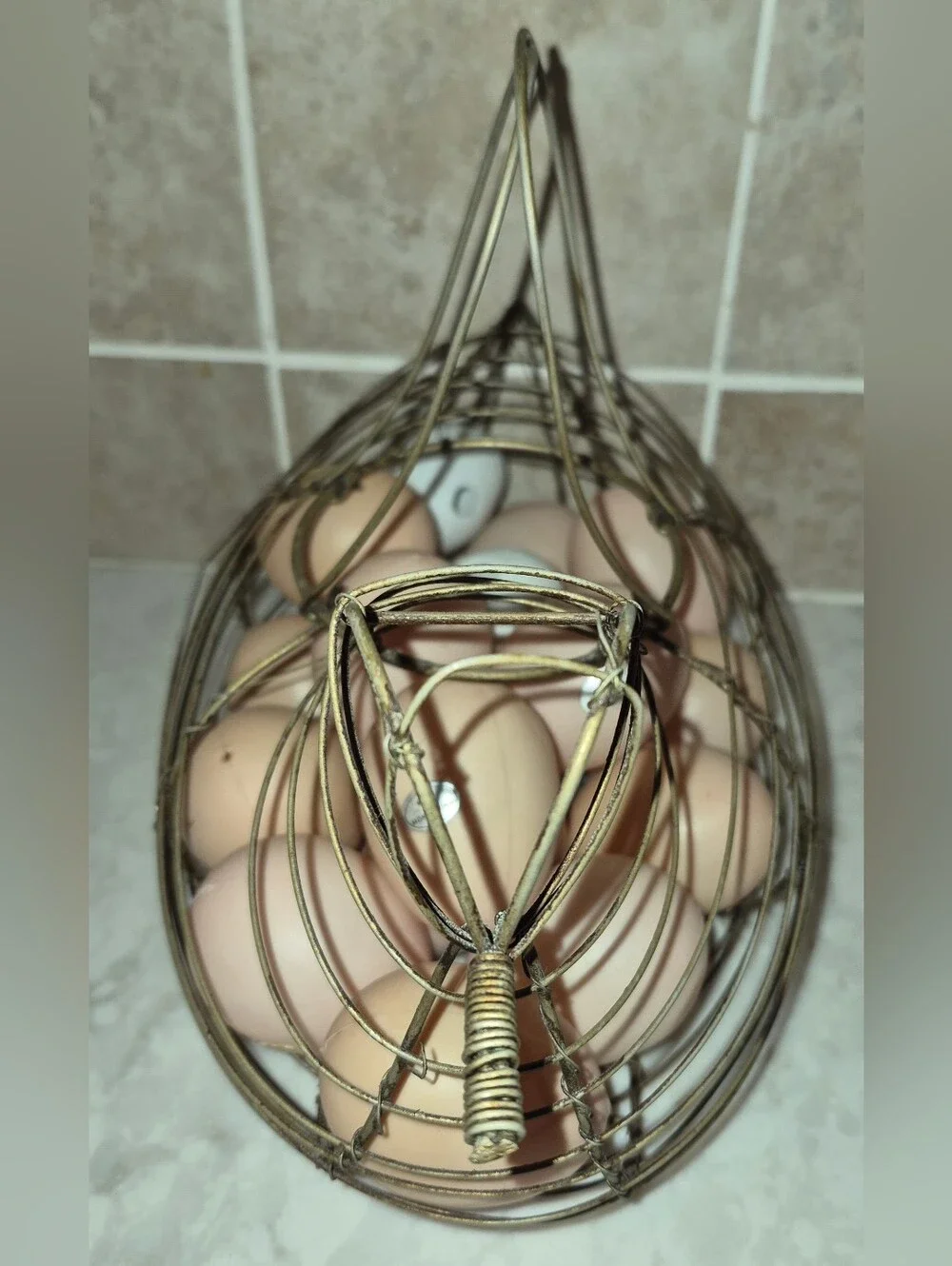 Vintage-style wire egg basket is shaped like a hen